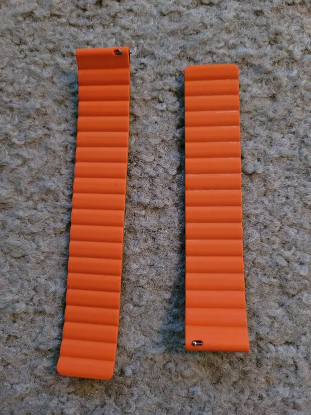 One black or orange watch band with magnetic closure